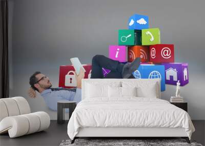 Businessman lying on the floor while reading a book against grey vignette Wall mural