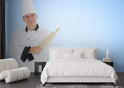 Chef with rolling pin against blue background Wall mural