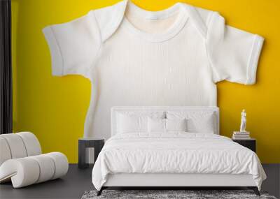 Close up of baby white t shirt with copy space on yellow background Wall mural