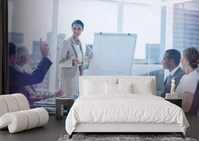 Colleagues asking a question to a businesswoman Wall mural