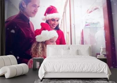 Composite image of family in christmas attire looking at jewelry Wall mural