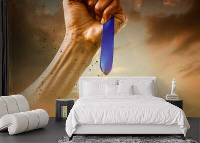 Composite image of hand holding a silver medal on white backgrou Wall mural