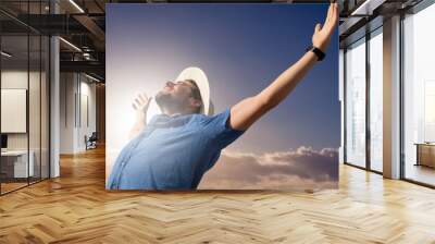 Composite image of happy man raising his arms up  Wall mural