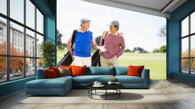 Composite image of men carrying golf equipment Wall mural