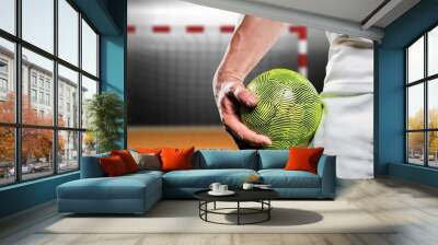 Composite image of sportsman holding a ball Wall mural