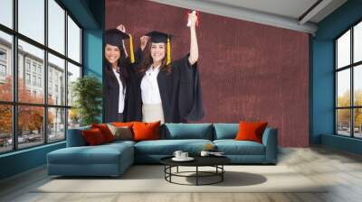 composite image of two women celebrating their graduation Wall mural