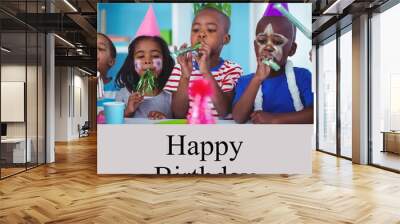 Composite of happy birthday text over happy diverse children at birthday party Wall mural