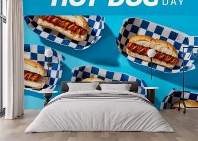 Composite of national hot dog day text with hot dogs in paper plate on blue background, copy space Wall mural