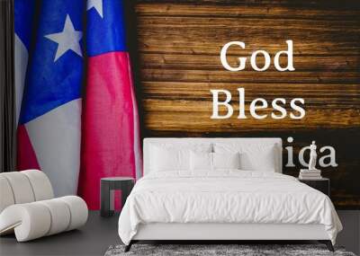 Composition of text god bless america with american flag on wood background Wall mural