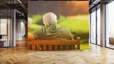 Couple sitting on the bench with their back to the camera Wall mural