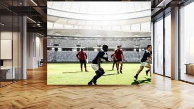 Digital composite image of team of rugby players playing rugby in sports stadium Wall mural