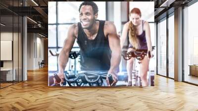 fit man working out at spinning class Wall mural