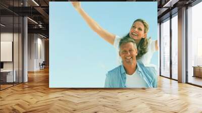 Happy couple having fun at beach Wall mural