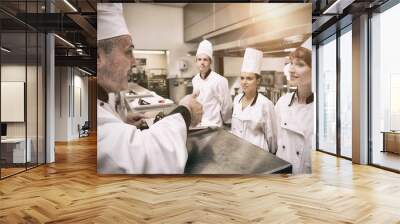 Head chef rating plate of one of his apprentices Wall mural