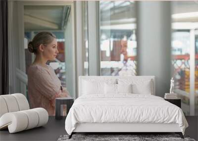 Image of happy boss day over of caucasian woman looking outside window in office Wall mural