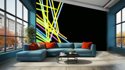 Image of vibrant stack of neon glow sticks scattered over black background with copy space Wall mural