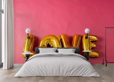 Metallic gold love text balloon on pink background with copy space Wall mural