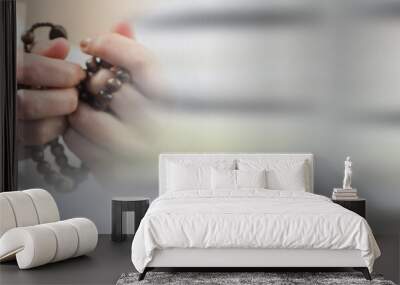 Mid section of a woman holding a rosary against grey background with copy space Wall mural