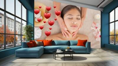 Multiple red heart icons against woman receiving a neck massage at a spa Wall mural