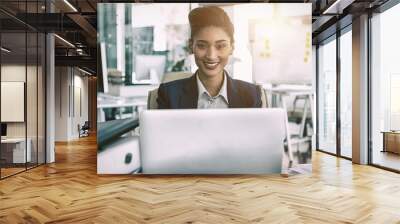 Portrait of smiling businesswoman by desk Wall mural