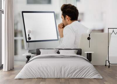 Rear view of businessman looking at computer monitor Wall mural