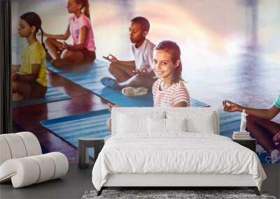 School kids meditating during yoga class Wall mural