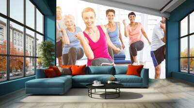 Smiling people doing power fitness exercise at yoga class Wall mural