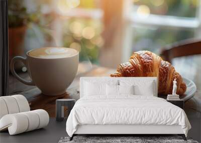 Morning coffee and croissant on a rustic wood table with soft lighting Wall mural