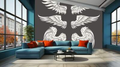 Set of vector illustrations of angelic or bird wings isolated on dark background, sketch, design element for tattoo Wall mural