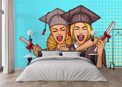 Vector pop art illustration of a two excited young girls graduate student in a graduation cap and mantle with a university diploma in their hands. The concept of celebrating the graduation ceremony Wall mural