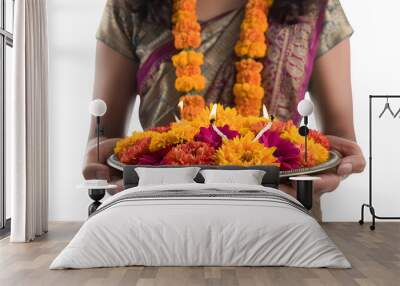 Woman holding a thali plate with diya and garland, Diwali, Indian culture, arti ceremony, traditional festival, festive celebration, png file, isolated on white Wall mural