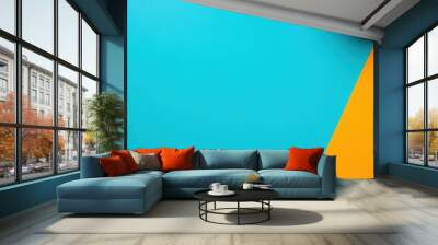 A vibrant composition featuring colorful notebooks and a leaf against a bright blue and orange backdrop, ideal for creative projects. Wall mural