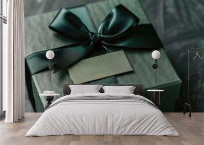 A beautiful green gift box wrapped with a ribbon and featuring a decorative tag Wall mural