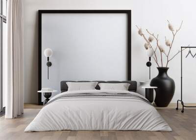 A black and white framed picture sits on a wooden table next to two vases Wall mural