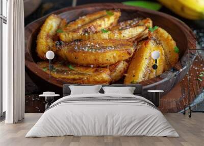 A bowl of fried bananas with a sprinkle of salt on top. The bowl is on a wooden table Wall mural