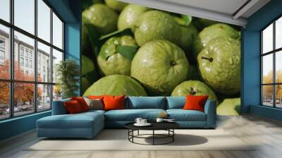 A bunch of green, organic limes with leaves attached, ready for harvest or display in a grocery market. Wall mural