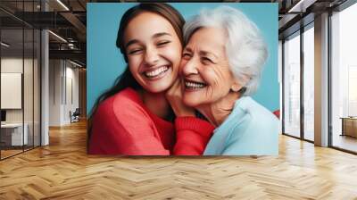 A heartwarming moment of connection between two women, set against a soothing blue background Wall mural