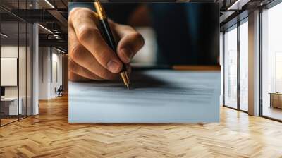 A man is writing with a pen on a piece of paper. Concept of formality and professionalism, as the man is dressed in a suit and tie Wall mural