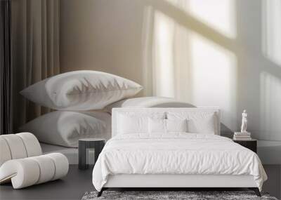 A set of three white, textured pillows stacked neatly on a bed. The sun shines through the window and casts an inviting glow on the room. Wall mural