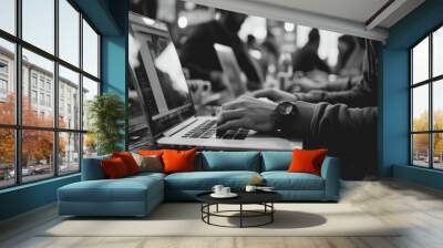 Black and white photo of person typing on laptop. Suitable for business, technology, and work-related concepts Wall mural