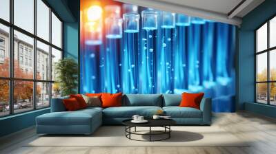 Row of blue test tubes with yellow light shining on them Wall mural