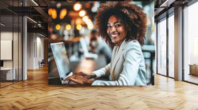 Woman is sitting at table and using laptop computer Wall mural