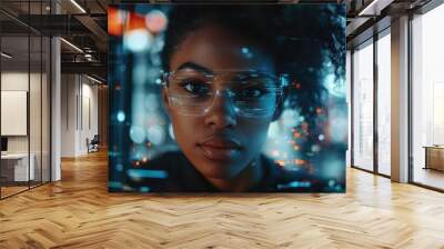 Woman with glasses is looking at a computer screen with a blurry background. Concept of technology and modernity, as well as a feeling of being disconnected from the physical world Wall mural