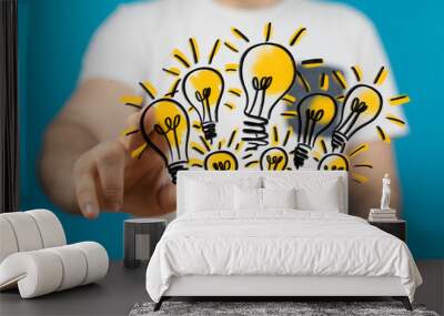  holding illuminated light bulb, idea, innovation and inspiration concept. Wall mural