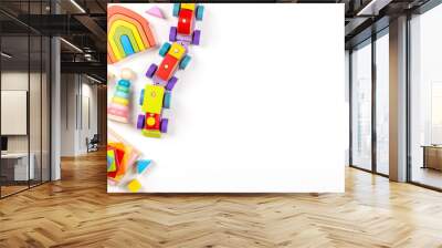 baby kids toys background. top view to wooden toy train, wood stacking pyramid tower and colorful wo Wall mural