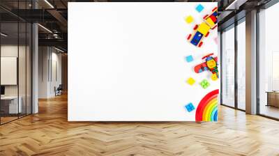 Baby kids toys background. Wooden train, red plane, stacking rings rainbow toy and colorful blocks. Top view, flat lay Wall mural