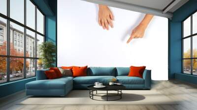 Children hands pointing on white background, top view Wall mural