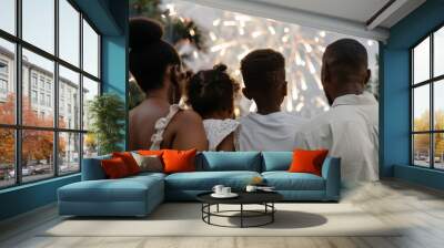 Happy African American family with children looking beautiful colorful holiday fireworks in the evening sky Wall mural