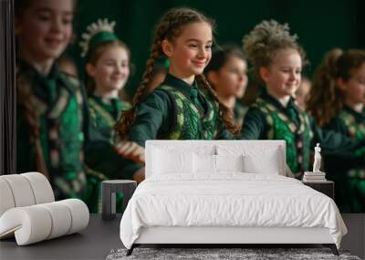 Little girls dance Irish dance. Little dancers perform on stage in traditional Irish dance attire during the St. Patrick's Day concert Wall mural