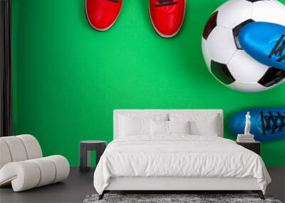 Soccer football sport background. Top view to soccer ball and boots on green background Wall mural